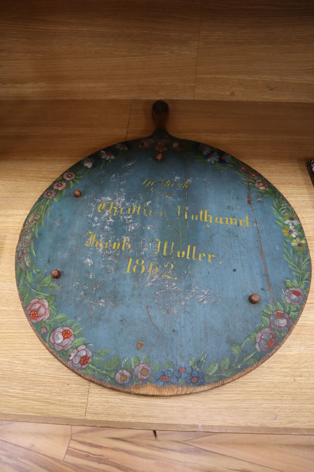 A mid 19th century Swiss painted board, inscribed and dated 1862, diameter 73cm